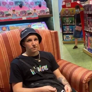 😴 Grim person, sitting, hat, t-shirt, furniture, store telegram sticker