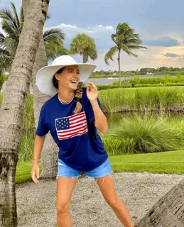 😂 woman, american flag, hat, shorts, palm trees, outdoors, golf course, smile telegram sticker