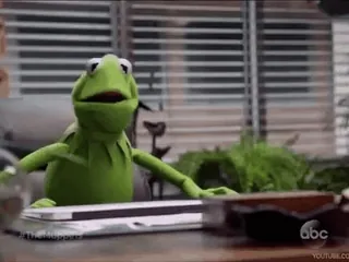 😟 Kermit the Frog Кермит, лягушка, кукла, мем, смешной, сидит, стол telegram sticker