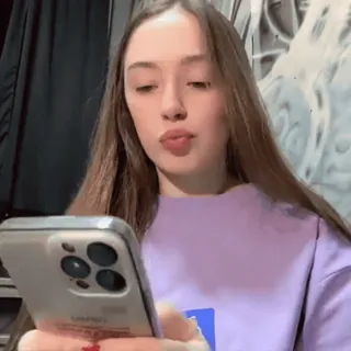 😣 girl, smartphone, looking at phone, vlog, portrait, video chat, young woman, smiling telegram sticker