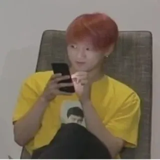 😂 person, sitting, chair, phone, indoor, yellow shirt telegram sticker