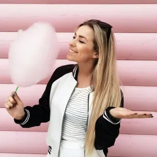 😲 woman, cotton candy, blonde hair, smiling, pink background, casual wear telegram sticker