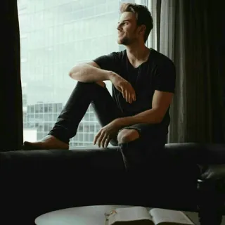 📎 man, window, sitting, book, casual, contemplative telegram sticker