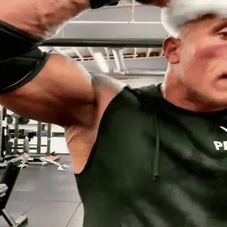 🤯 0cb4e840 The Rock Dwayne Johnson, muscoloso, fitness, cappello da Babbo Natale, palestra telegram sticker