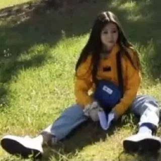 😕 9e453eed woman, grass, sitting, casual, outdoors telegram sticker