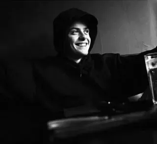 ▫️ 12c6bdc5 osoba, bluza z kapturem, napój, stół, uśmiechnięty, czarno-białe, portret telegram sticker