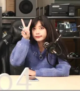 ✌️ 796e9efc woman, peace sign, indoors, chair, microphone telegram sticker