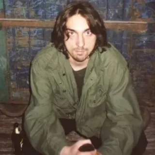 😳 f85a4da2 man, green jacket, sitting, long hair whatsapp sticker