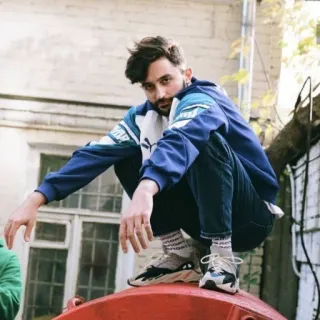 😎 f3633817 man, squatting, sneakers, portrait, casual, outdoors telegram sticker