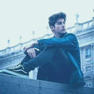 😏 0d2c60ca young man, sitting, casual wear, urban, building telegram sticker