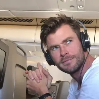 😕 dbea960c Chris Hemsworth actor, celebrity, headphones, airplane telegram sticker